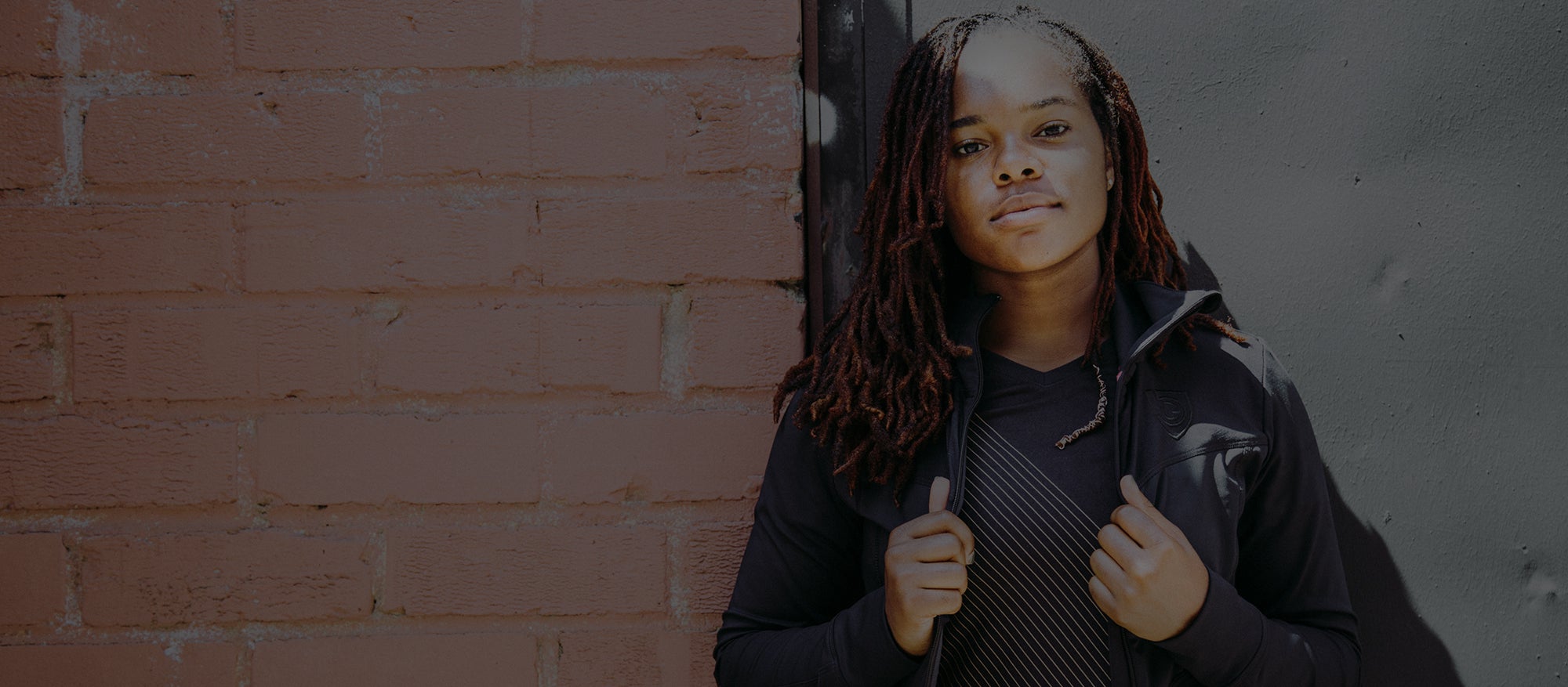 A woman wears Goal Five gear, available by redeeming Goal Five gift cards for athletes.