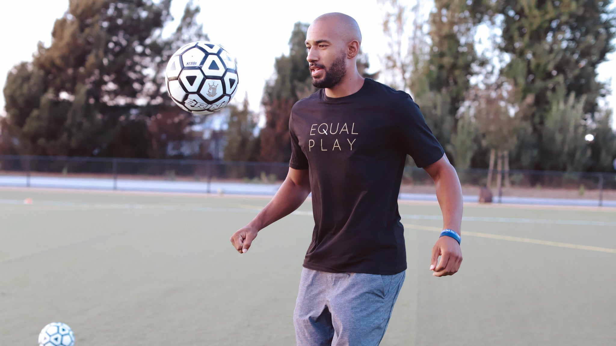 A man trains in a t-shirt from the Goal Five men's athletic clothes collection.