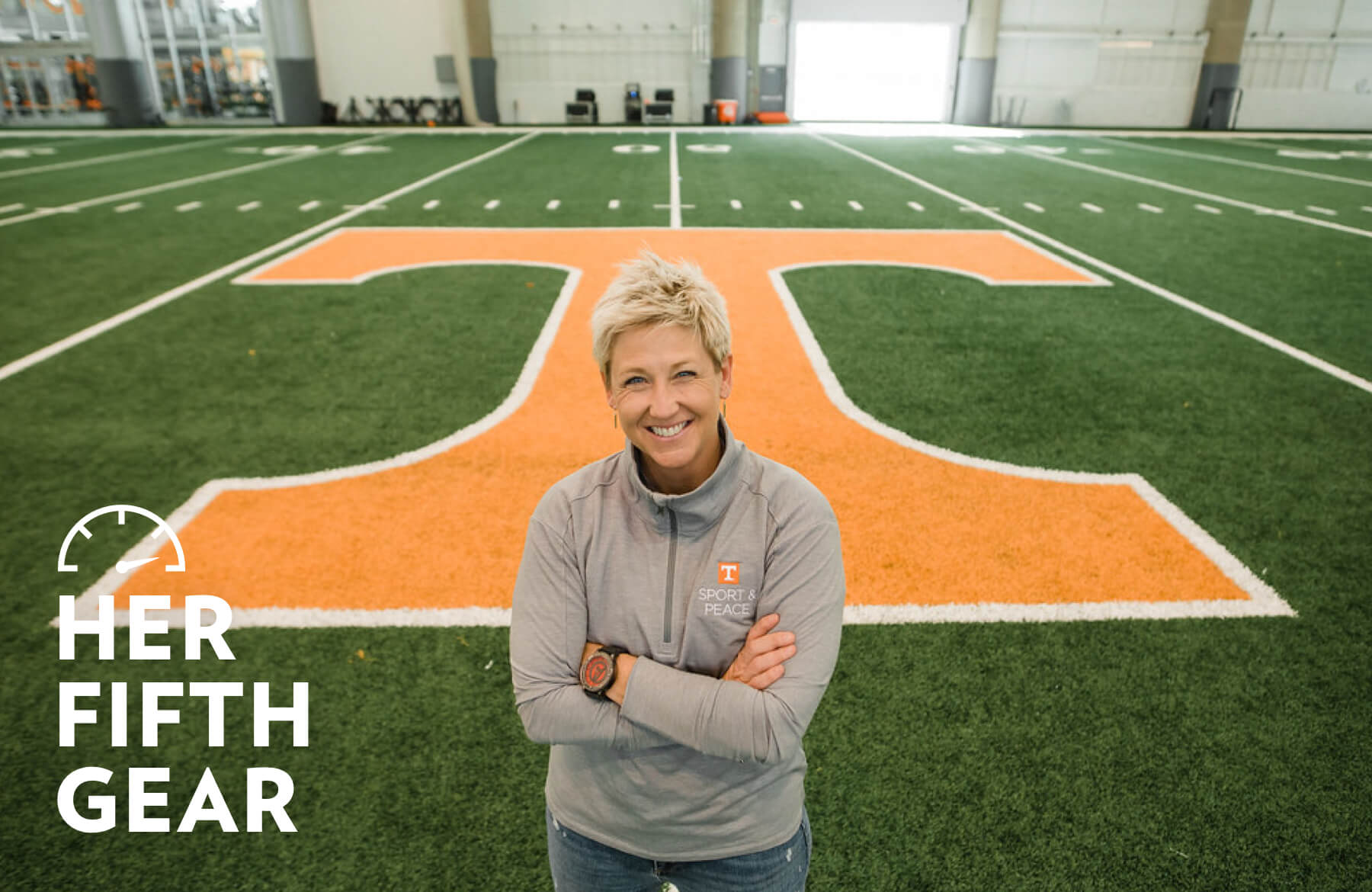 Dr. Sarah Hillyer standing beside a field at the University of Tennessee