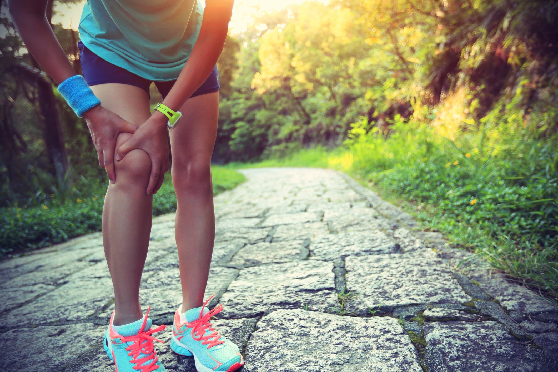 woman holding her knee after a sports injury
