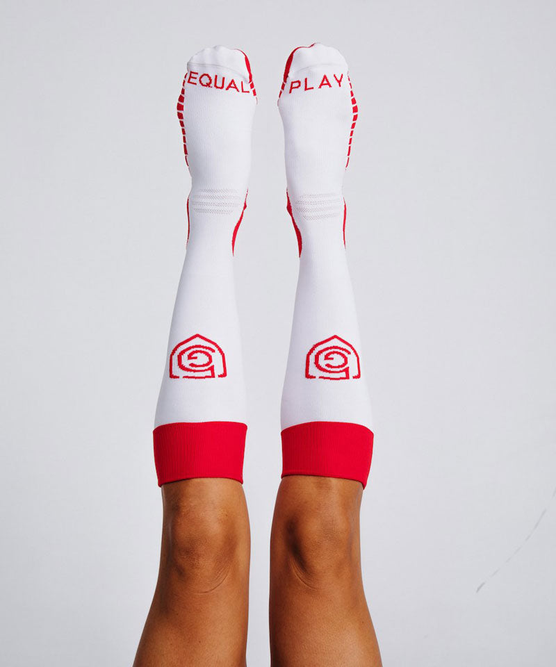 The model features the Goal Five logo and Equal Play text on our OTC socks.