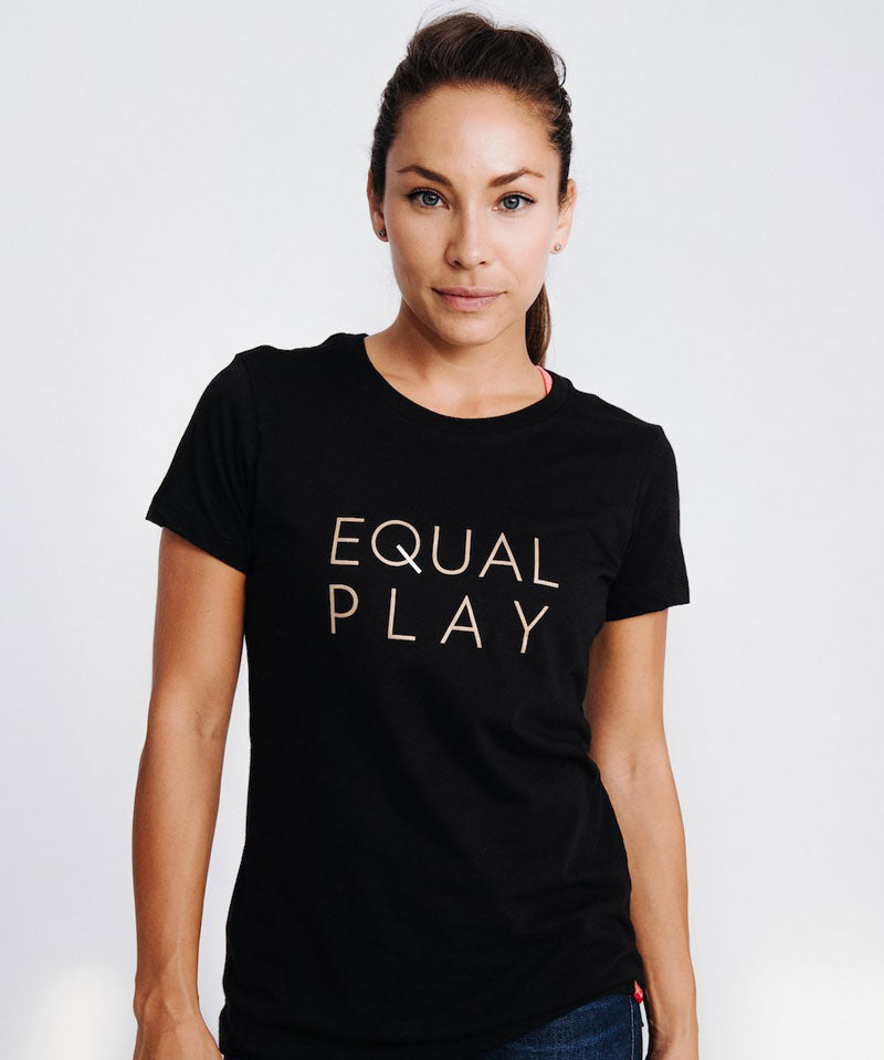 A woman poses in a black Equal Play women's soccer t-shirt.