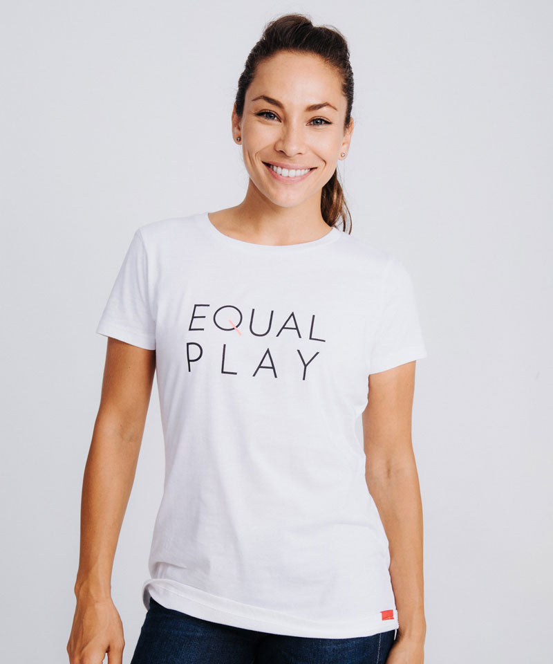 A model smiles wearing the Equal Play women's soccer t-shirt in white.