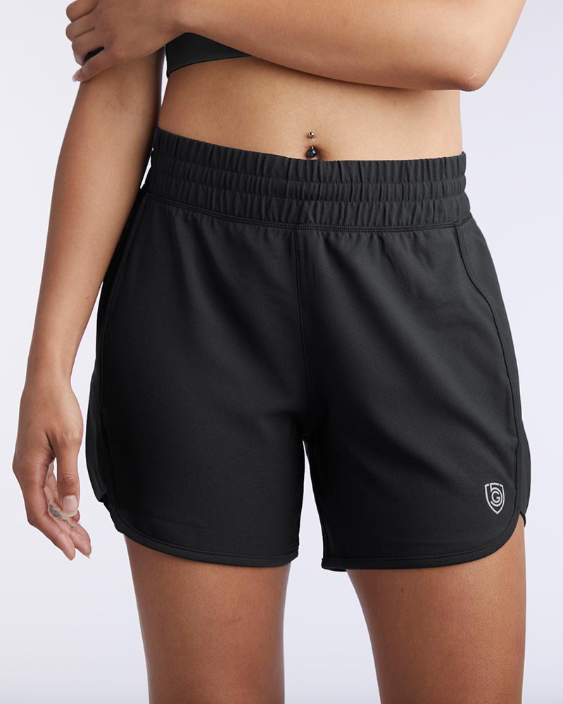 A woman wears Indie women's sport shorts in black.