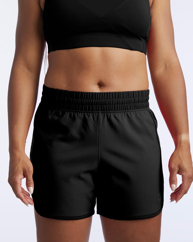 A model wears high-rise Indie women's sport shorts in black.