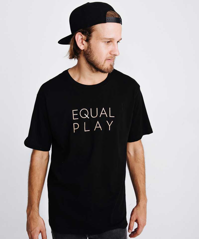 A model shows the front Equal Play text on the men's athletic T shirt.