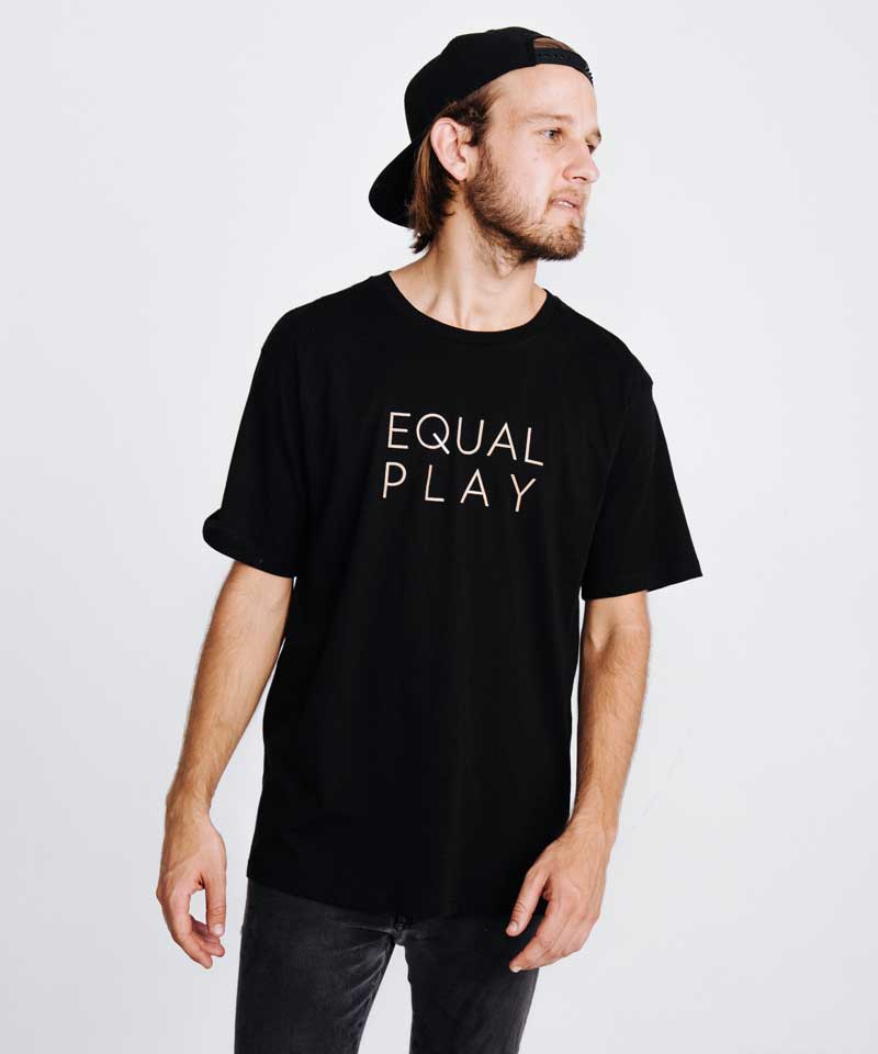 A man poses wearing the Equal Play men's athletic T shirt.